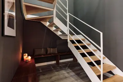 a spiral staircase in a room with a table at Tortosa - 3 bedrooms and a terrace in Les Corts in Barcelona