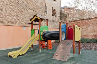 a bedroom with a bed and a desk with a desk at Tortosa - 3 bedrooms and a terrace in Les Corts in Barcelona
