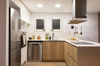 a kitchen and dining room with a table with wine glasses at Amandi - 2 bedrooms in Gràcia in Barcelona