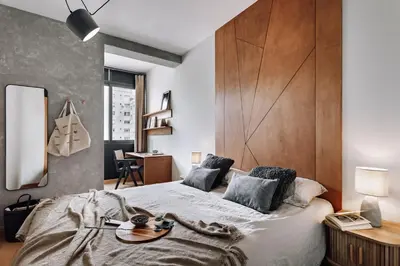 a bedroom with a large bed with a wooden headboard at Biescas - 1 bedroom in Eixample Esquerra in Barcelona