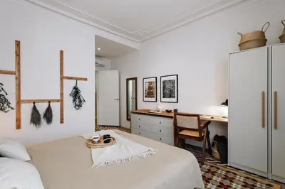a wall with three pictures and a clock on it at Olvera - 3 bedrooms in Eixample Dreta in Barcelona