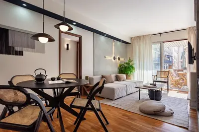 a living room with a table and a couch at Mitaka - 3 bedrooms and terrace in Eixample Dreta in Barcelona