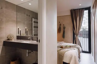 a bedroom with a large mirror and a bed at Pedrera - 2 bedrooms in Eixample Esquerra in Barcelona