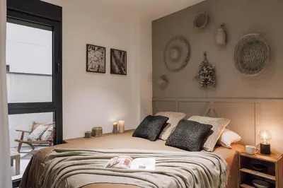a living room with a table and chairs and a couch at Pedrera - 2 bedrooms in Eixample Esquerra in Barcelona