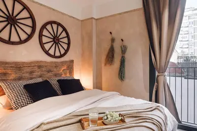 a bedroom with a bed with black and white pillows at Pedrera - 2 bedrooms in Eixample Esquerra in Barcelona