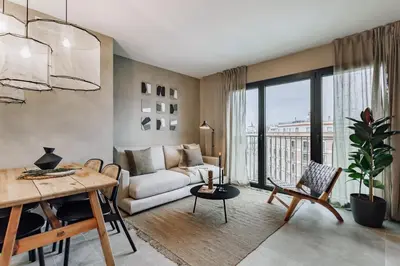a living room with a couch and a table at Mont - 2 bedrooms and office in Eixample Esquerra in Barcelona