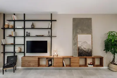 a living room with a television on a wooden entertainment center at Mont - 2 bedrooms and office in Eixample Esquerra in Barcelona