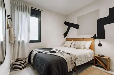 a living room with a table and a couch at Mont - 2 bedrooms and office in Eixample Esquerra in Barcelona