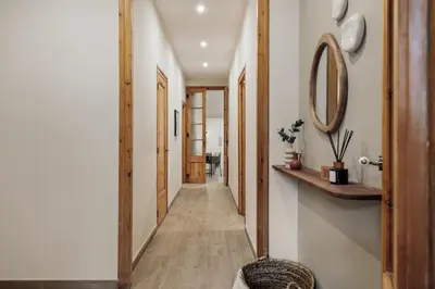 a hallway with a door and a mirror at Kaax - 3 bedrooms and balcony in Eixample in Barcelona
