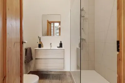 a white bathroom with a sink and a shower at Kaax - 3 bedrooms and balcony in Eixample in Barcelona