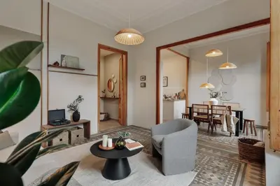 a kitchen with white cabinets and a wooden table at Kaax - 3 bedrooms and balcony in Eixample in Barcelona