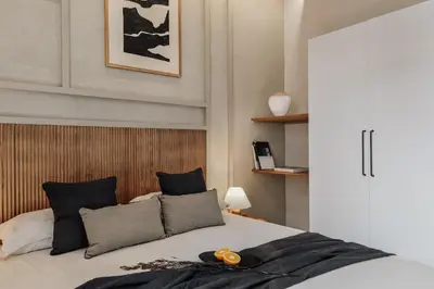 a bedroom with a large bed with two lamps at Atitlan - 3 bedrooms, office and balcony in Eixample Esquerra in Barcelona