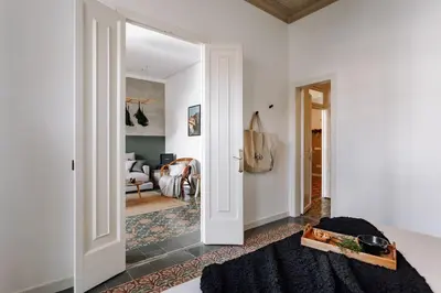 a bedroom with a bed with a tree behind it at Baeza - 2 bedrooms and office in Eixample Esquerra in Barcelona
