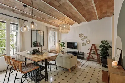 a kitchen with a wooden table and chairs at Cape - 2 bedrooms in Gràcia in Barcelona
