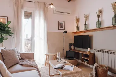 a hallway with white walls and large windows at Lugros - 3 bedrooms in Gràcia in Barcelona