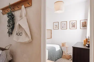 a bedroom with a bed and a bag on the wall at Lugros - 3 bedrooms in Gràcia in Barcelona