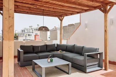 a bedroom with a large white bed with two lamps at Batipaglia - 2 bedrooms and terrace in Ciutat Vella in Barcelona