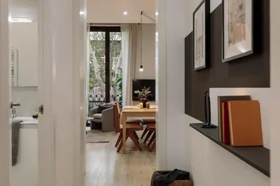 a kitchen and living room with a couch and a table at Chuck - 2 bedrooms and balcony in Sant Antoni in Barcelona