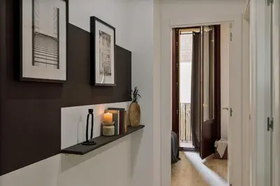 a dining room with a wooden table and chairs at Chuck - 2 bedrooms and balcony in Sant Antoni in Barcelona