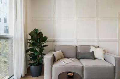 a living room with a table and chairs and a tv at Sabia - 2 bedrooms in Poblenou in Barcelona