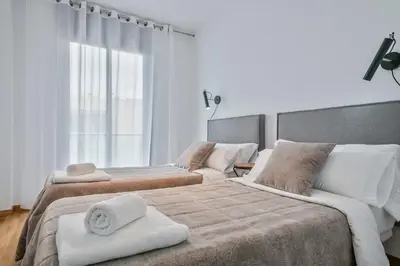 a bedroom with two beds with towels on them at Modern Penthouse with Large Terrace in Poblenou Perfect for Holidays or Work Close to the Beach and Public Transport in Barcelona