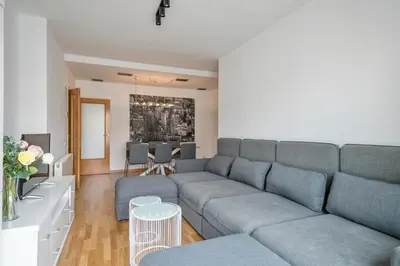 a living room with a couch and a table at Modern Penthouse with Large Terrace in Poblenou Perfect for Holidays or Work Close to the Beach and Public Transport in Barcelona