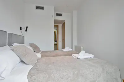 a bedroom with two beds with white pillows at Modern Penthouse with Large Terrace in Poblenou Perfect for Holidays or Work Close to the Beach and Public Transport in Barcelona