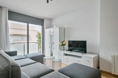 a living room with a couch and a tv at Modern Penthouse with Large Terrace in Poblenou Perfect for Holidays or Work Close to the Beach and Public Transport in Barcelona