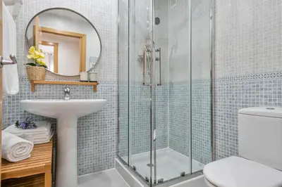 a bathroom with a glass shower and a sink at Modern Penthouse with Large Terrace in Poblenou Perfect for Holidays or Work Close to the Beach and Public Transport in Barcelona