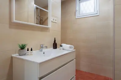 a bathroom with a sink and a mirror at Cozy and Modern Apartment in Poblenou 3 Bedrooms Perfect for 4 Guests in Barcelona