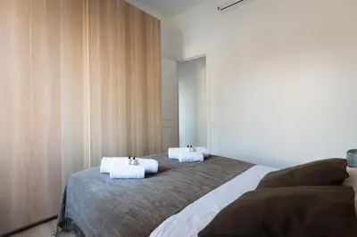 a bedroom with two beds with white towels on them at Cozy and Modern Apartment in Poblenou 3 Bedrooms Perfect for 4 Guests in Barcelona