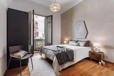 a bedroom with a large bed with a large headboard at Vico - 4 bedrooms and office in Eixample Dreta in Barcelona