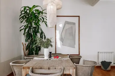 a dining room with a wooden table and chairs at Vico - 4 bedrooms and office in Eixample Dreta in Barcelona