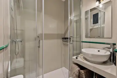 a bathroom with a sink and a glass shower at Meko - 2 bedrooms and balcony in Eixample Esquerra in Barcelona