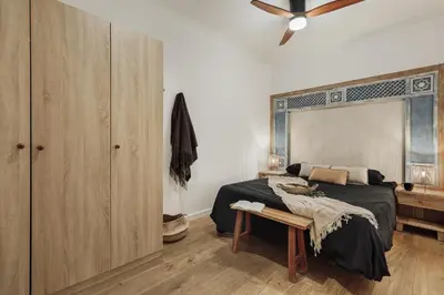 a dining room with a wooden table and chandeliers at Meko - 2 bedrooms and balcony in Eixample Esquerra in Barcelona