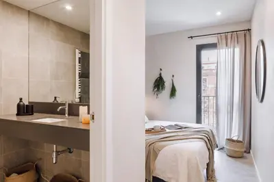a bathroom with a bed and a sink in a room at Dabo - 3 bedrooms in Eixample Esquerra in Barcelona