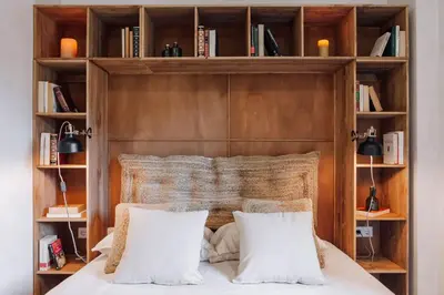 a bedroom with a wooden headboard with two pillows at Dabo - 3 bedrooms in Eixample Esquerra in Barcelona