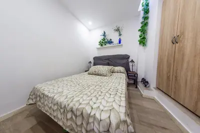 a bedroom with a bed in a white room at Terrace & BEACH apartment in Calella