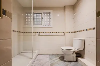 a white bathroom with a toilet and a shower at Casa en Barcelona in Barcelona