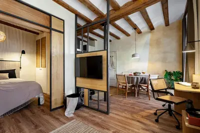 a living room with a couch and a table at Atuh - Studio and terrace in El Born in Barcelona