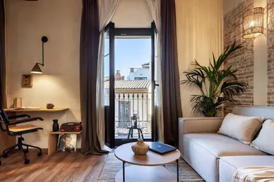 a living room with a couch and a table at Atuh - Studio and terrace in El Born in Barcelona
