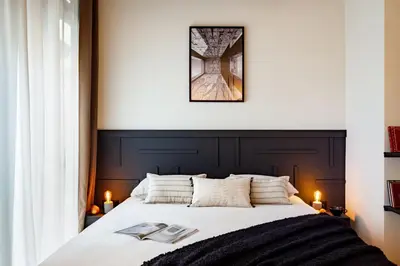 a bedroom with a large bed with two books on it at Baharya - 2 bedrooms in Eixample Dreta in Barcelona