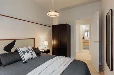 a bedroom with a bed and a large window at Garraf - 2 bedrooms and balcony in Sant Gervasi in Barcelona