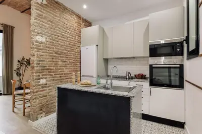 a patio with a table and chairs and a hammock at Malang - 2 bedrooms with terrace in Gràcia in Barcelona