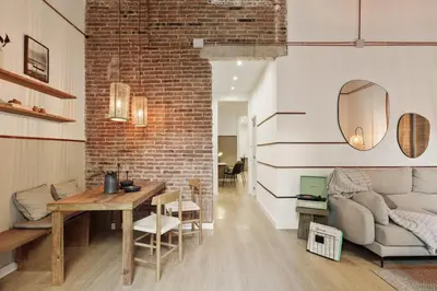 a dining room with black chairs and tables at Malang - 2 bedrooms with terrace in Gràcia in Barcelona