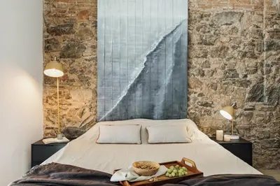 a room with a table and chairs and a brick wall at Malang - 2 bedrooms with terrace in Gràcia in Barcelona