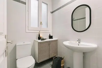 a white bathroom with a sink and a mirror at Albori - 2 bedrooms and balcony in Eixample Dreta in Barcelona