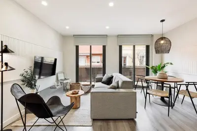a bedroom with a bed and a desk and a table at Falco - 2 bedrooms with shared pool in Les Corts in Barcelona