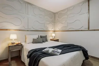 a bedroom with a large bed with two lamps at Yaxha - 4 bedrooms and terrace in Eixample Dreta in Barcelona