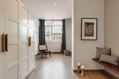a hallway with a chair and a mirror at Yaxha - 4 bedrooms and terrace in Eixample Dreta in Barcelona